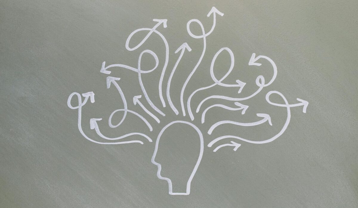 Conceptual chalk drawing illustrating mental health challenges with arrows representing thoughts.